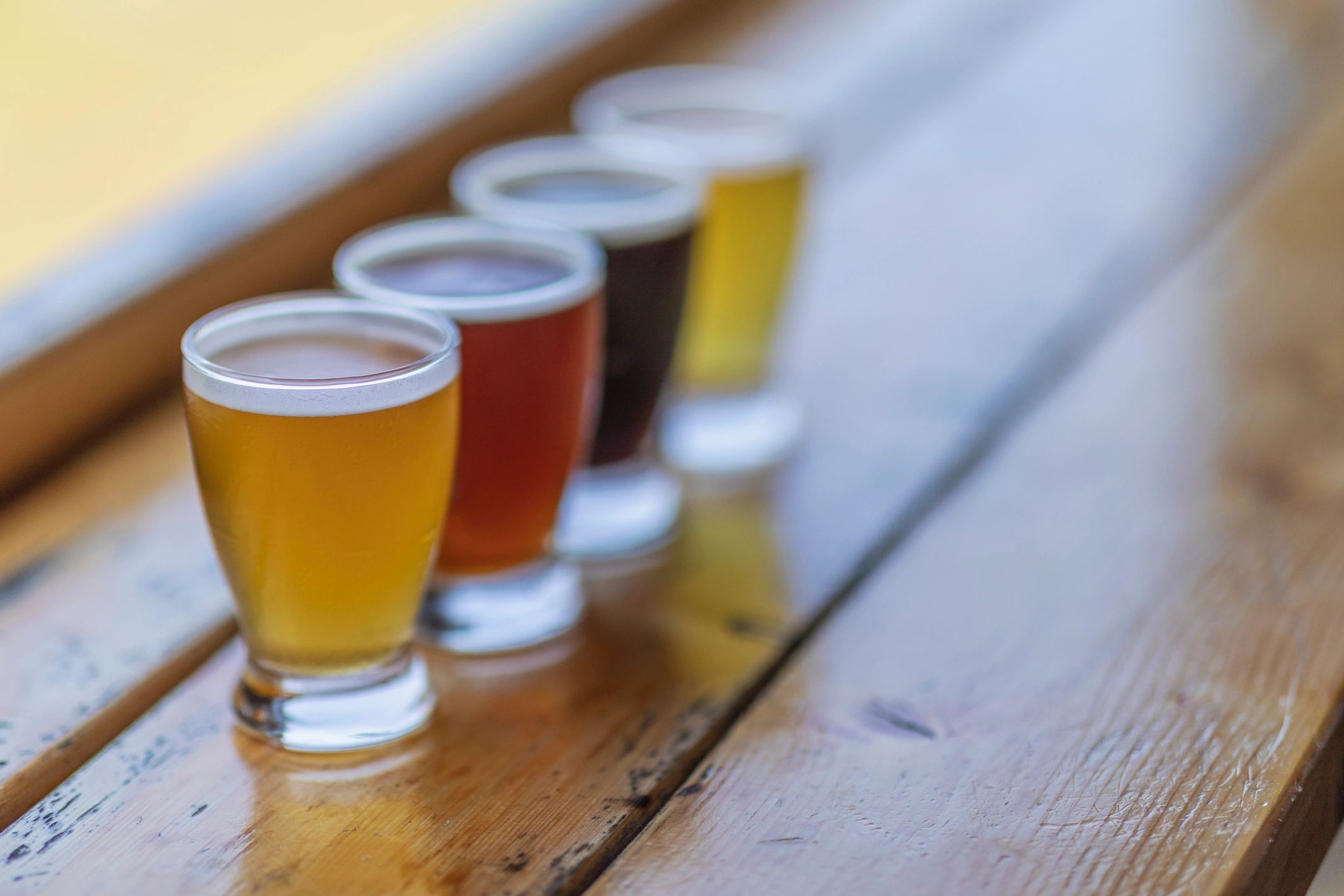 Four-beer flight on a wooden table