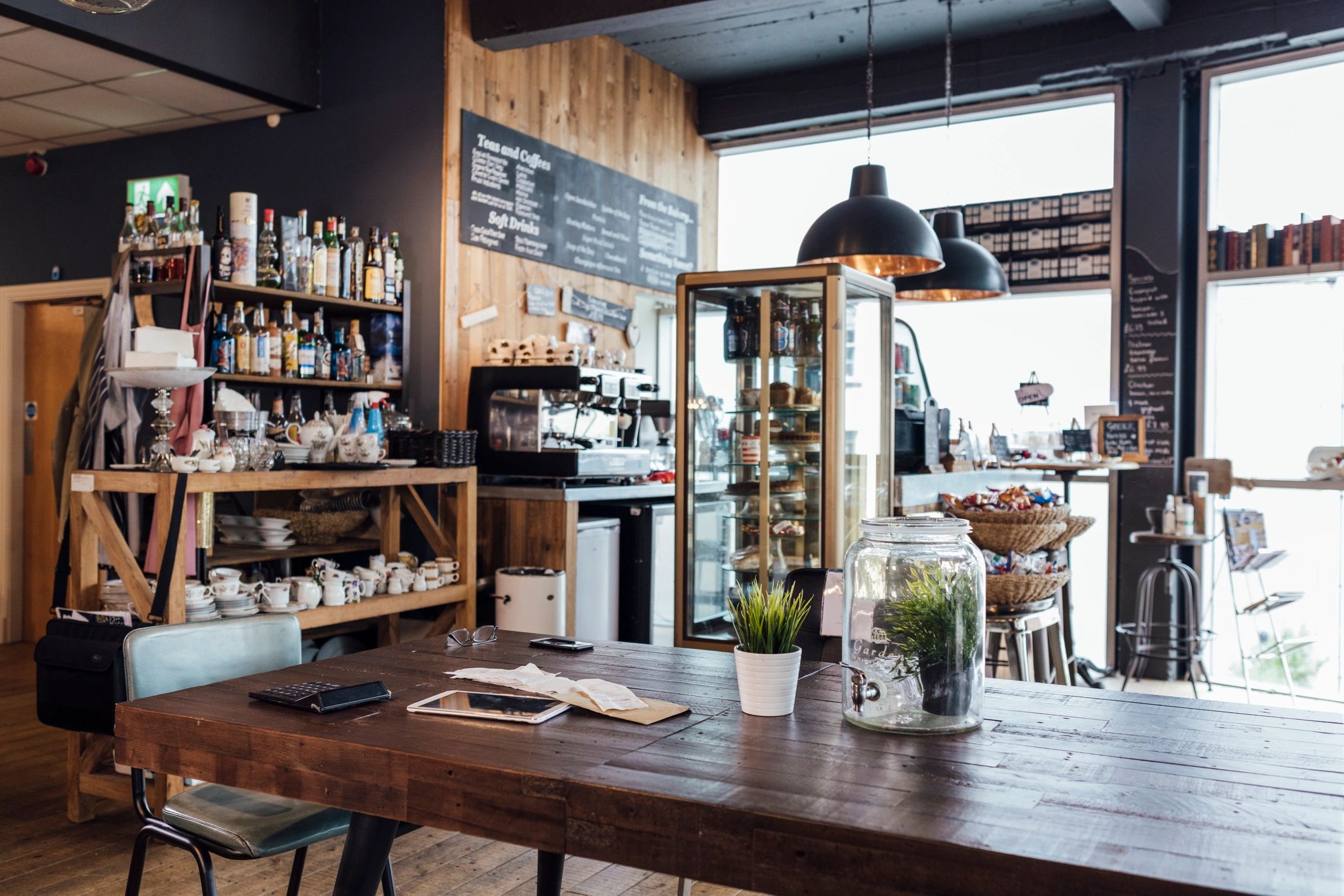 Empty rustic cafe interior with wood tables and natural light
